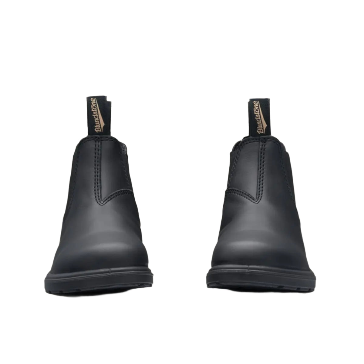 Pair of black rubber boots on a beige background