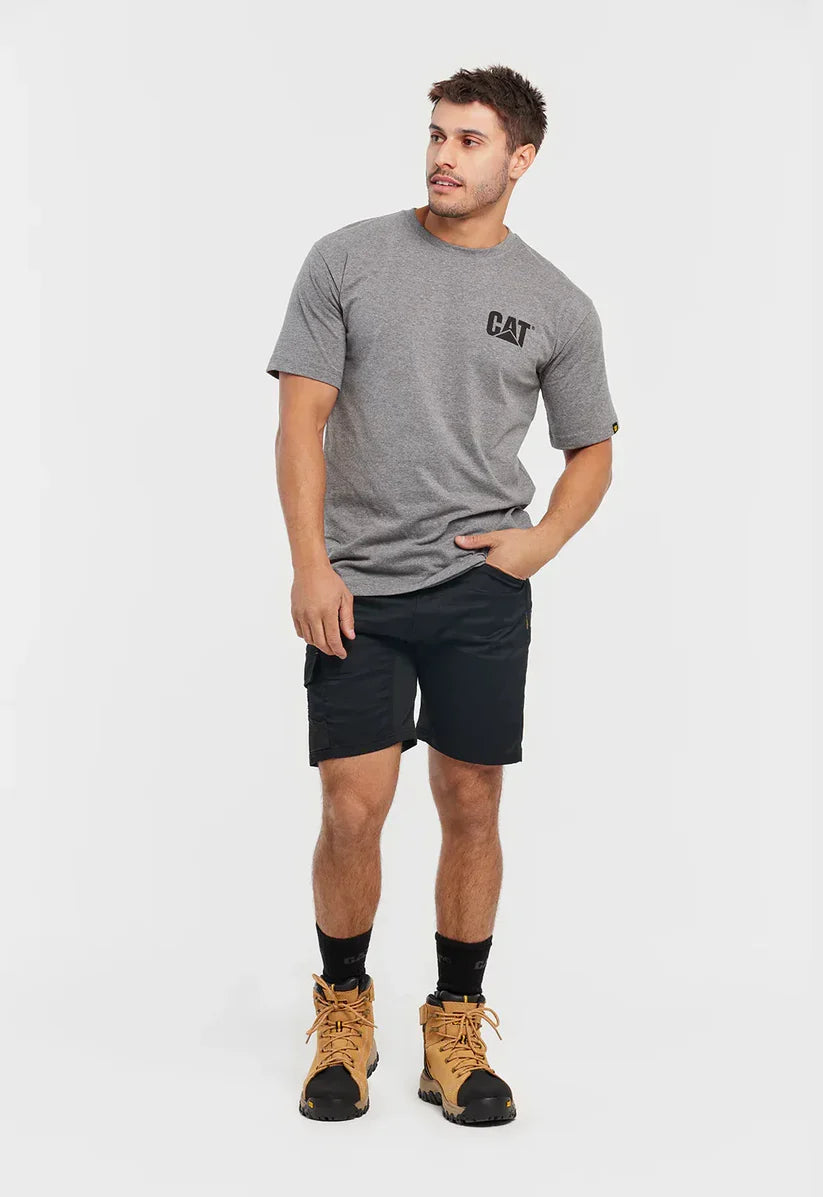 Man wearing a gray t-shirt with a logo, black shorts, and brown boots on a white background